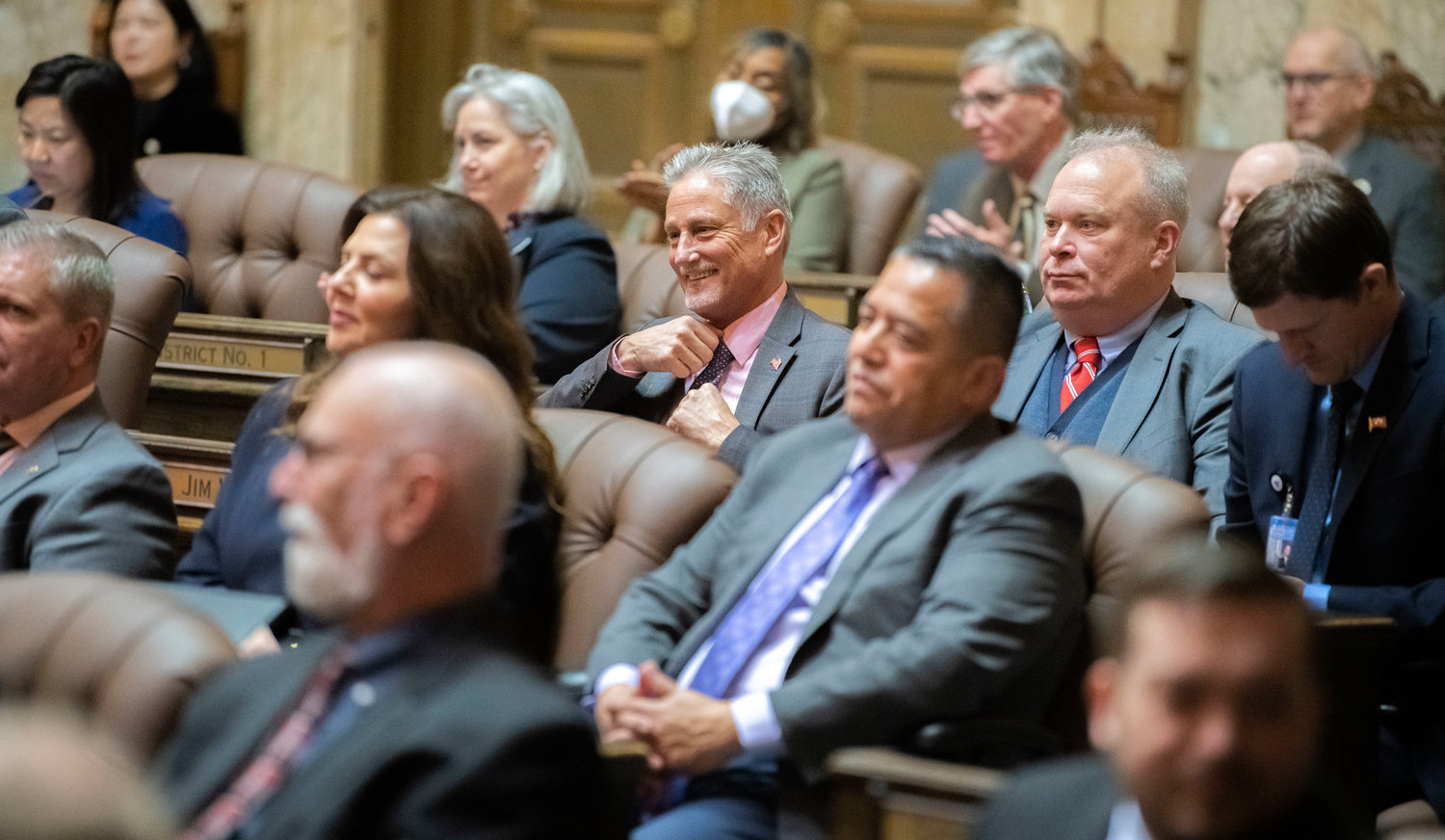 Senator Jeff Wilson smiles while attending Inlsee’s 2023 State of the State speech alongside State Rep. Jim Walsh Tuesday afternoon in Olympia.