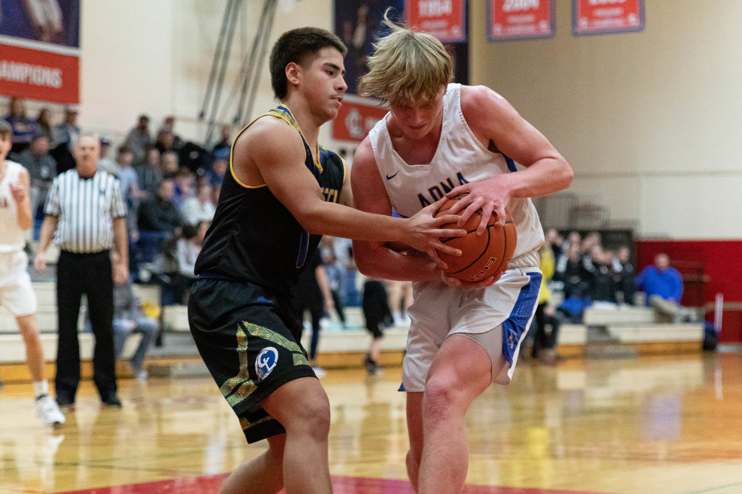 Adna forward Lane Johnson grapples for possession with a Chief Leschi defender Jan. 16 at the MLK Classic at Lower Columbia College in Longview.