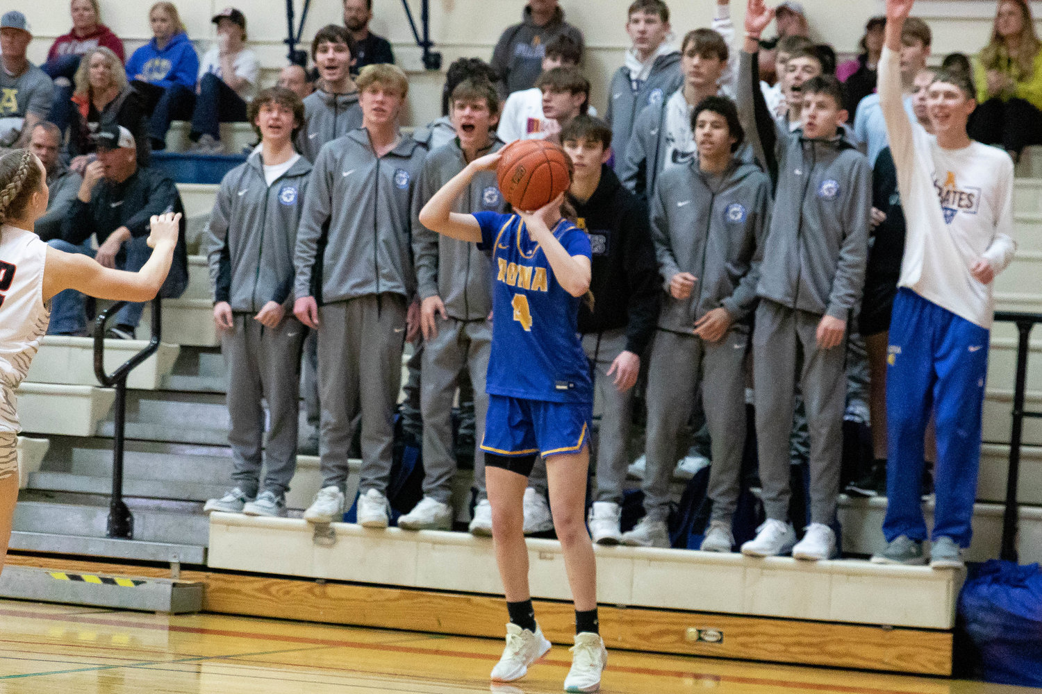 Adna guard Brooklyn Loose shoots a 3-pointer from the corner as the boys hoops team cheers her on against Napavine at the MLK Classic in Longview at Lower Columbia College Jan. 16.