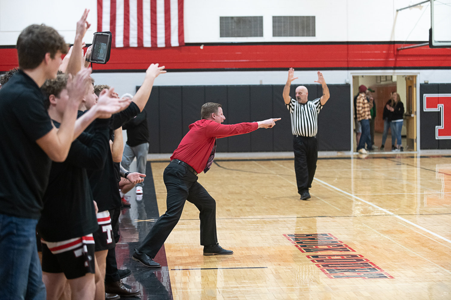 Ryan Robertson and the Tenino bench celebrate a 3-pointer during the second half of the Beavers' win over Mossyrock on Jan. 18.