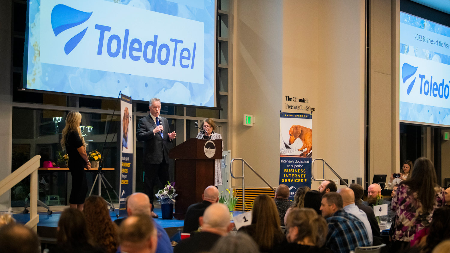 ToledoTel Vice President and CEO Dale Merten stands on The Chronicle Presentation Stage after accepting the Business of the Year Award Friday night at Centralia College.