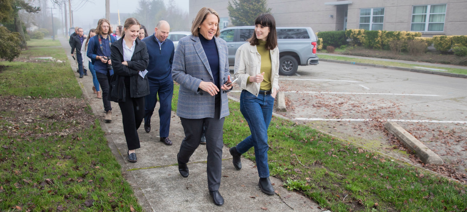 Marie Gluesenkamp Perez smiles while walking alongside Monica Brummer, director of the Pacific Northwest Center of Excellence for Clean Energy at Centralia College, during a tour of the campus on Friday.