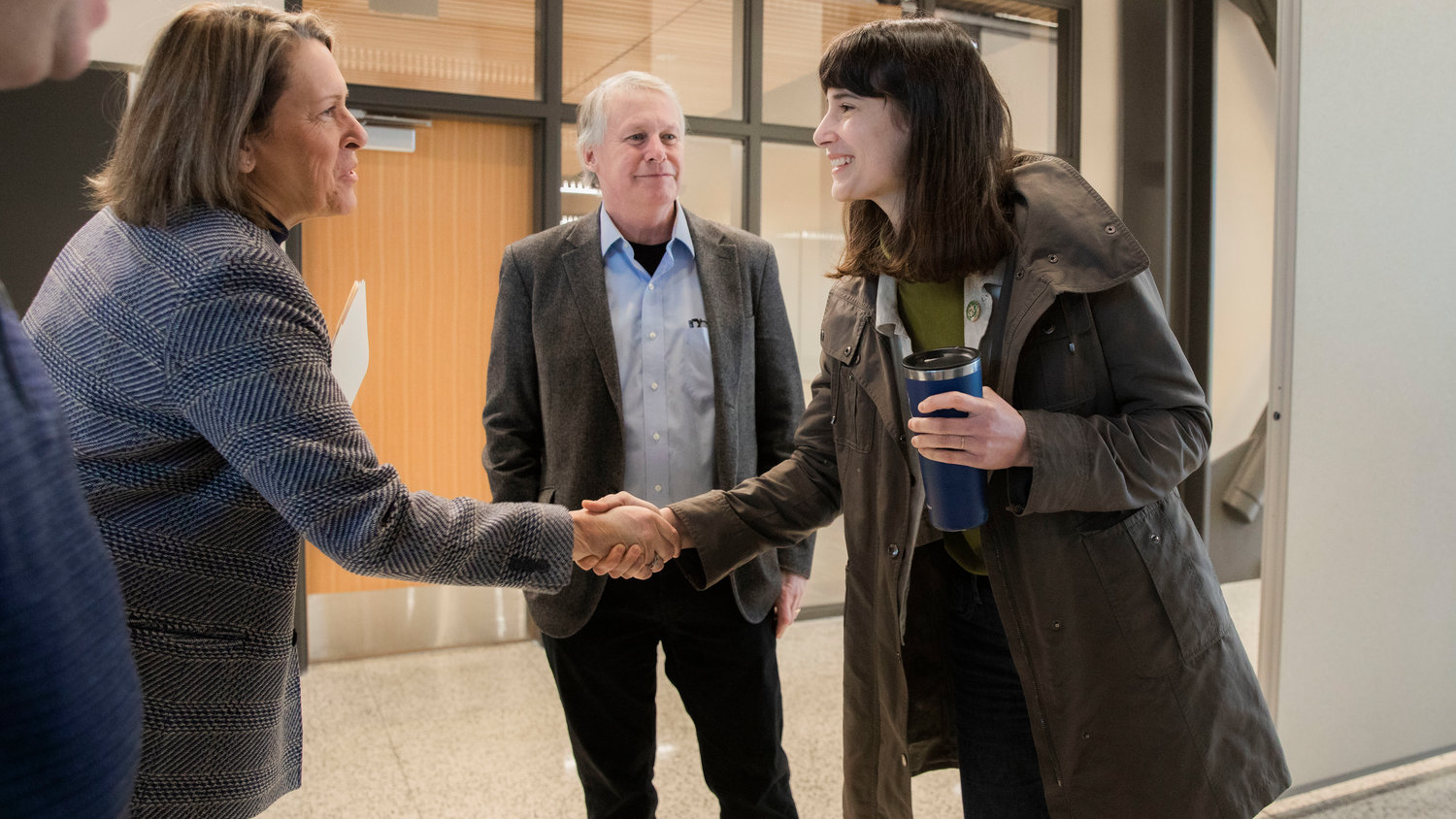 Marie Gluesenkamp Perez smiles and shakes hands with Monica Brummer, director of the Pacific Northwest Center of Excellence for Clean Energy at Centralia College, alongside Court Stanley during a tour of the campus on Friday.