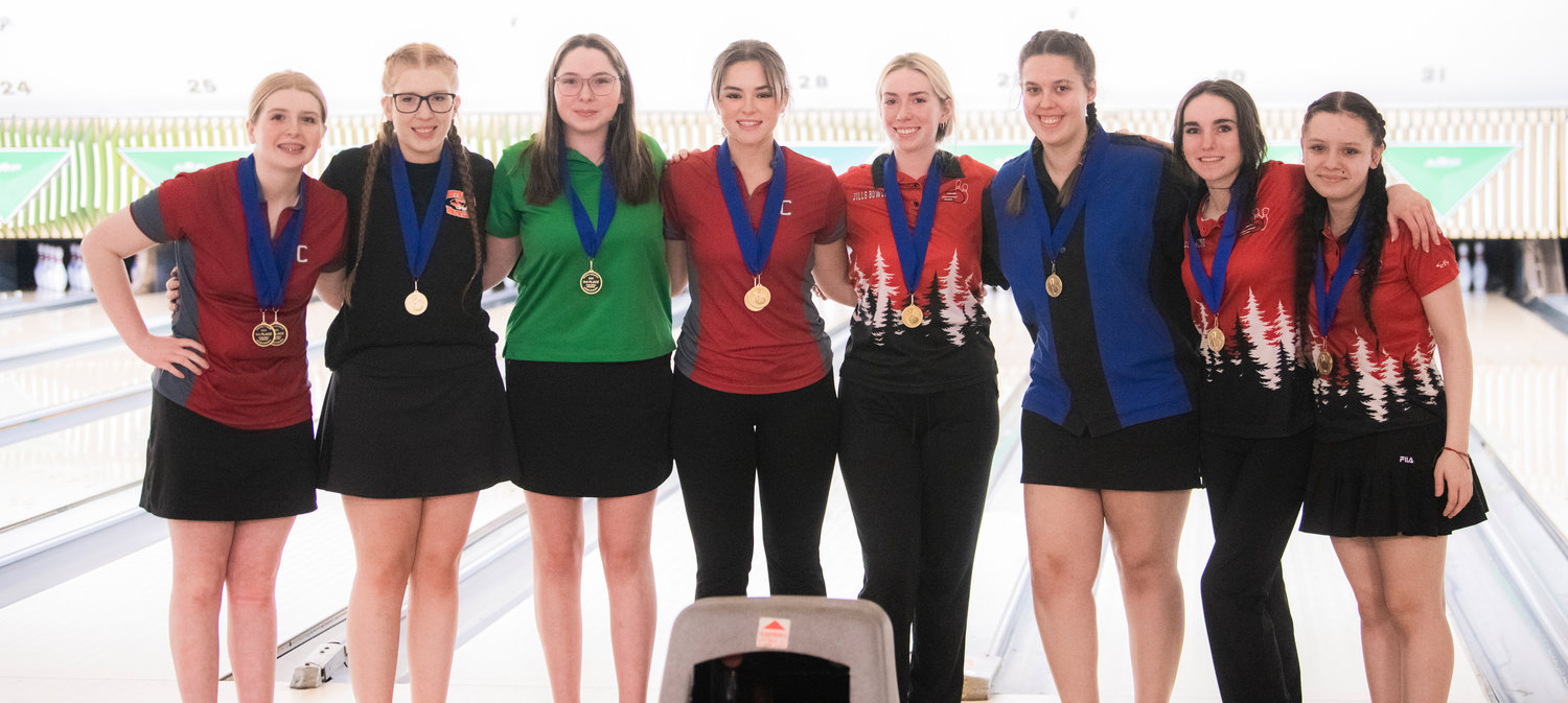 From left, W.F. West’s Piper Chalmers, Centralia’s Bailee Spriggs, Tumwater’s Hailey Hopkins, W.F. West’s Clara Bunker, R.A. Long’s Ava Rodman, Mark Morris’ Mahalia Perkins and R.A. Long’s Lily Mattison and Jade Walters smile for a photo after placing within the top nine bowlers at Westside Lanes in Olympia.