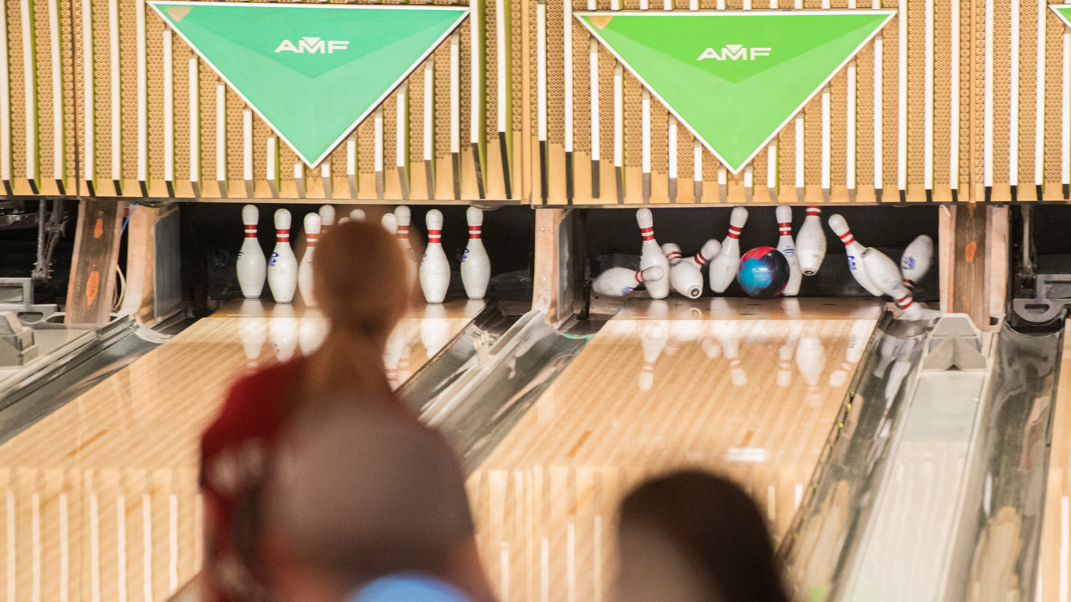 Pins explode out of formation as W.F. West scores a strike at Westside Lanes in Olympia.