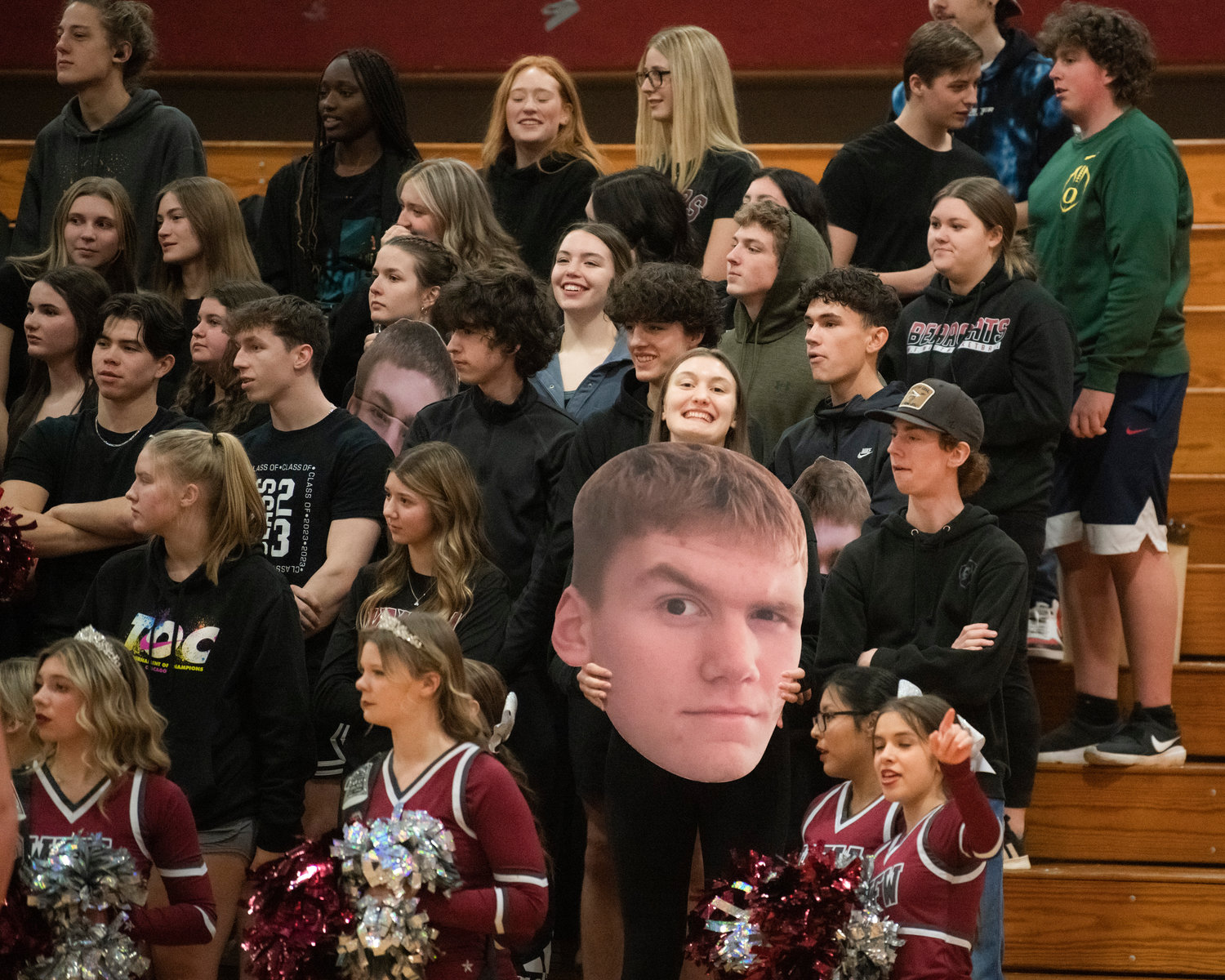 Julia Dalan holds up a cut out of her brother Soren during a Tuesday night game in Chehalis.