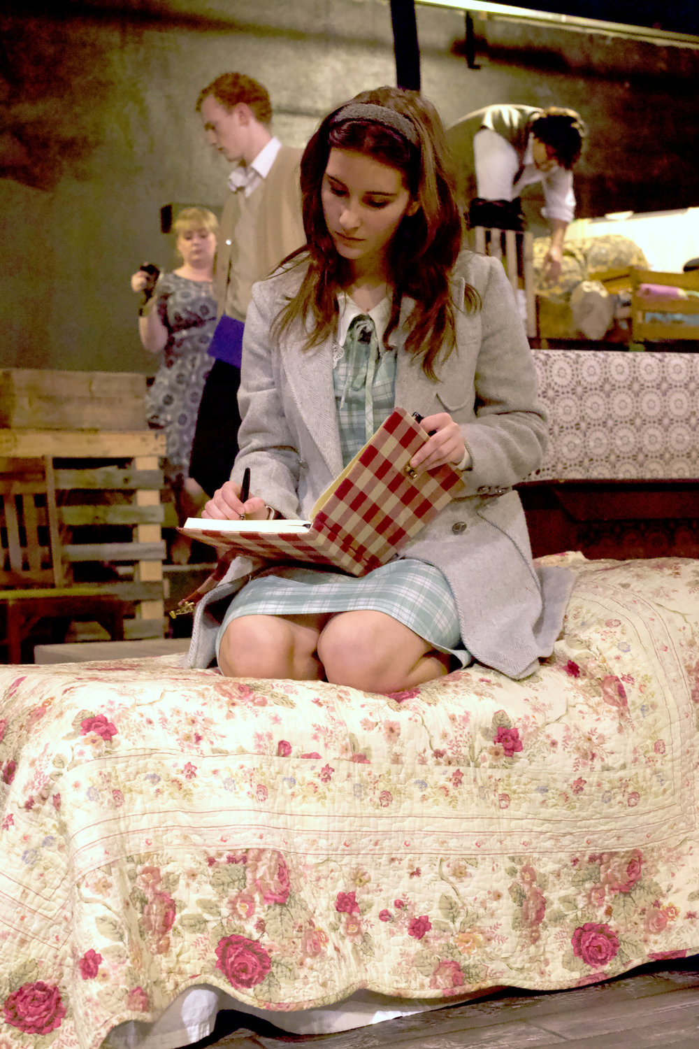 Anne Frank, played by Ruby Stanton, writes in her diary during a rehearsal of “The Diary of Anne Frank” at the Evergreen Playhouse in Centralia last week.