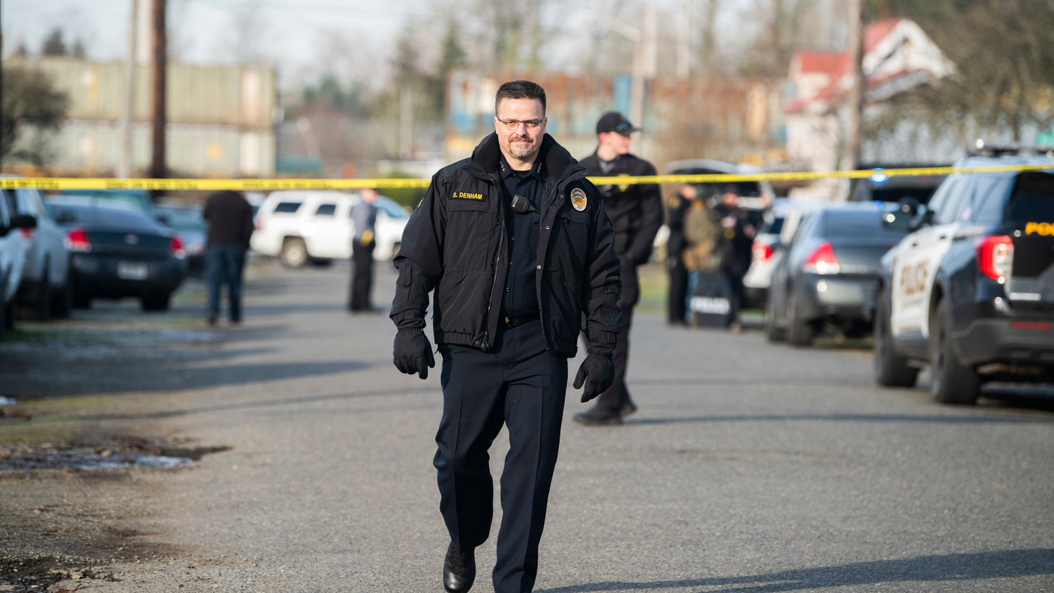 Centralia Police Chief Stacy Denham walks through an active scene where a man barricaded himself in a building in the 1300 block of Windsor Avenue in Centralia on Thursday.
