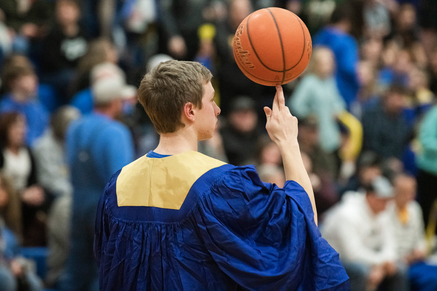 A student spins a basketball on his finger during a break in a game on Thursday in Adna.