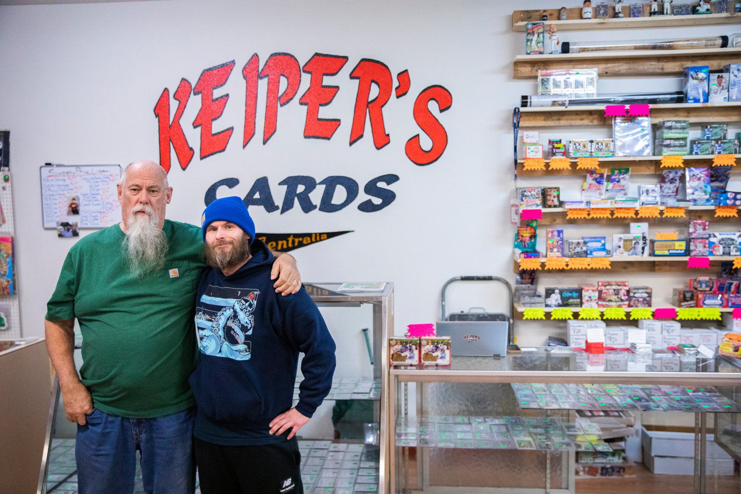 Charlie Redmon and Dan Keiper pose for a photo inside Keiper’s Cards in downtown Centralia on Thursday.