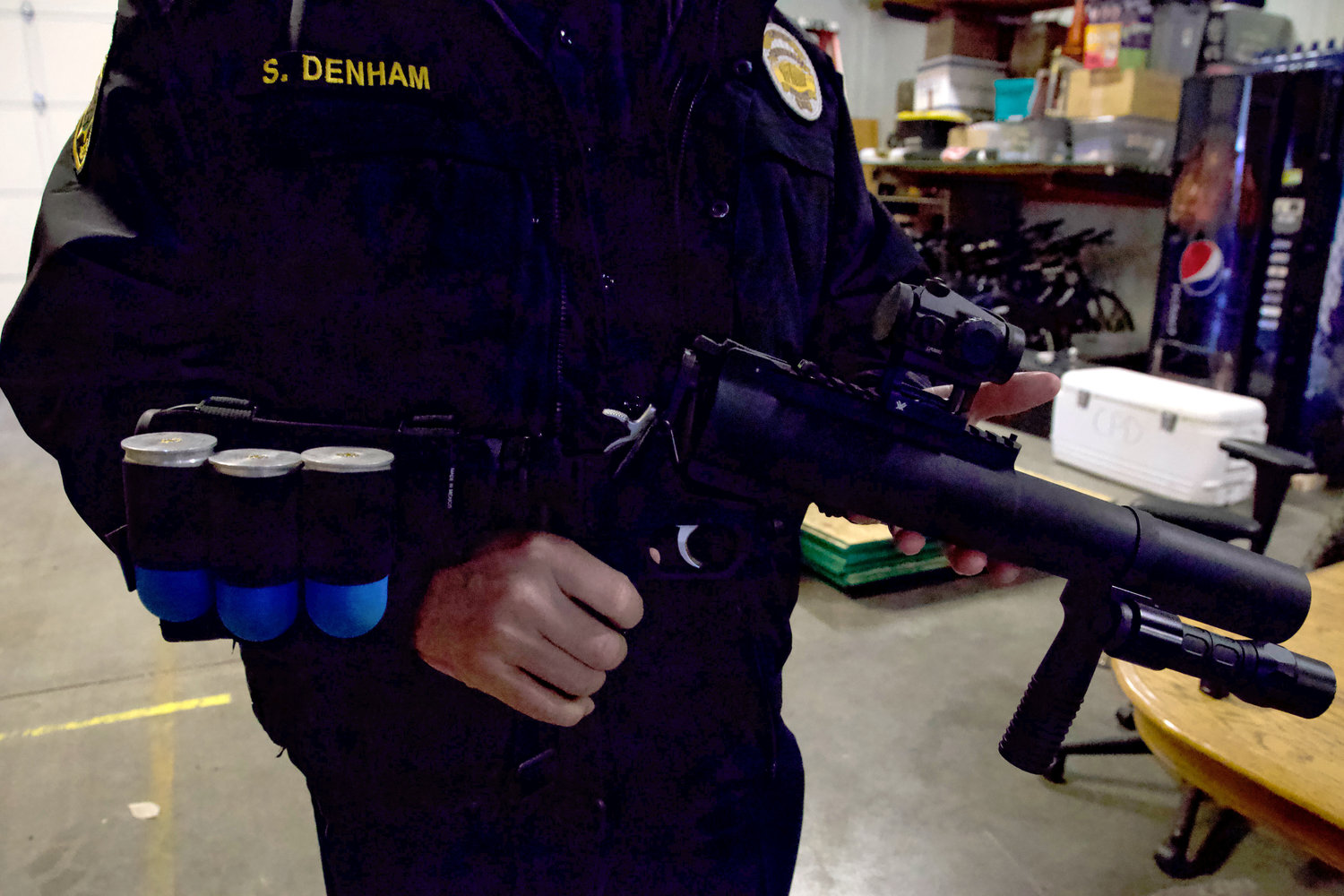 Centralia Police Department Chief Stacy Denham holds a 40 mm less-lethal round launcher during a training at the department’s Mellen Street facility on Thursday. “It’s one of those tools that if we can deploy this and save one person’s life, it’s worth it,” Denham said.
