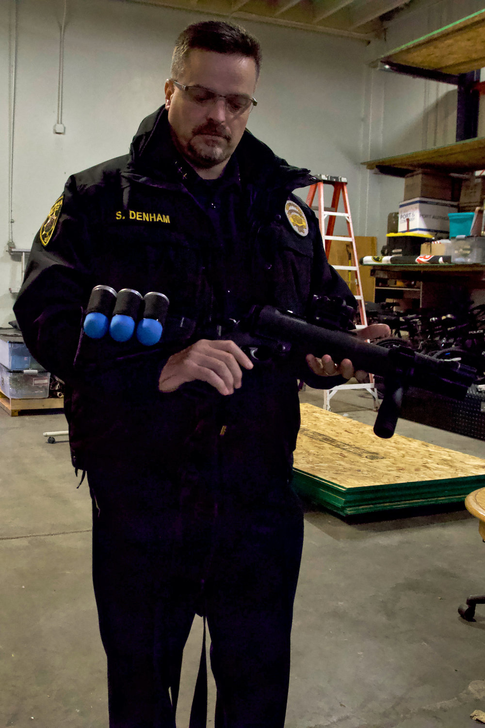 Centralia Police Department Chief Stacy Denham holds a 40 mm less-lethal round launcher during a training at the department’s Mellen Street facility on Thursday.