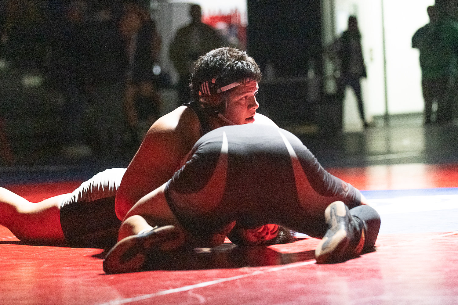 W.F. West's Daniel Matagi takes a quick look up while holding his opponent down during the heavyweight finals at the 2A Evergreen Sub-Regional Tournament at Black Hills on Feb. 4.