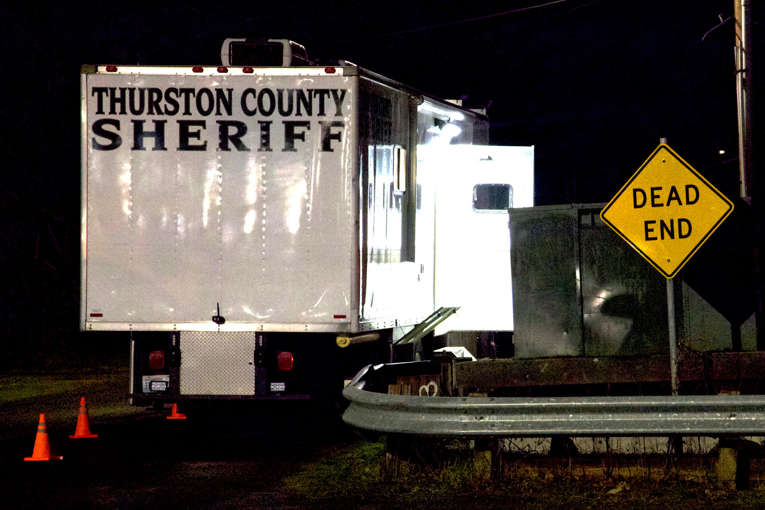 The Thurston County Mobile Command Center sits outside a private property in the 1100 block of Eckerson Road as law enforcement attempts to negotiate with an armed individual deeper into the property Sunday night. 