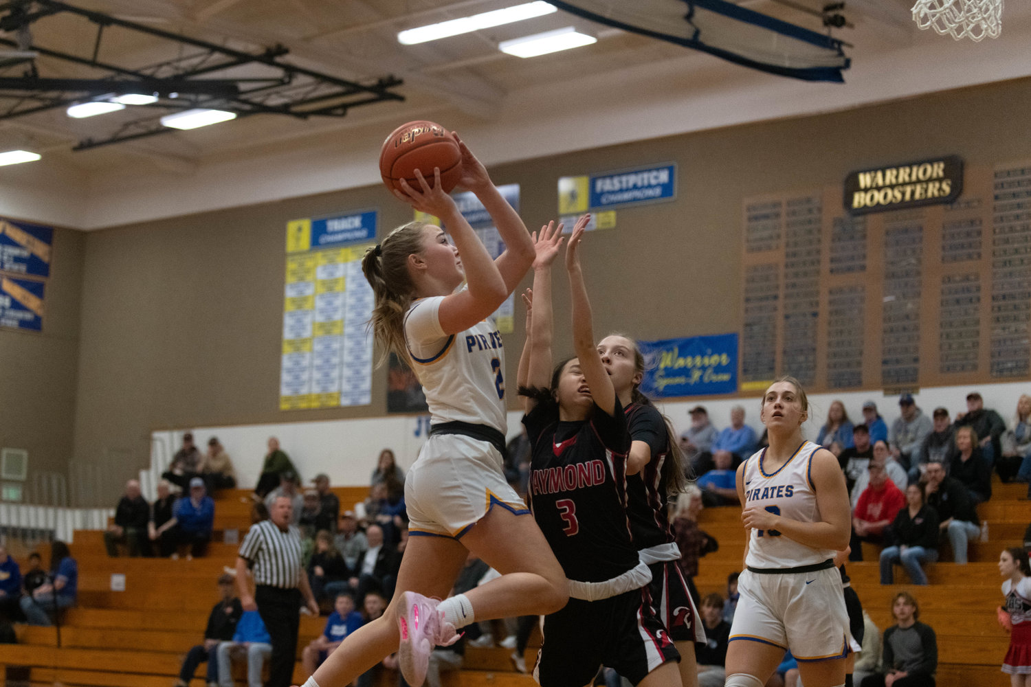 Danika Hallom goes through contact to the basket during the first quarter of Adna's district matchup against Raymond at Rochester on Feb. 7.