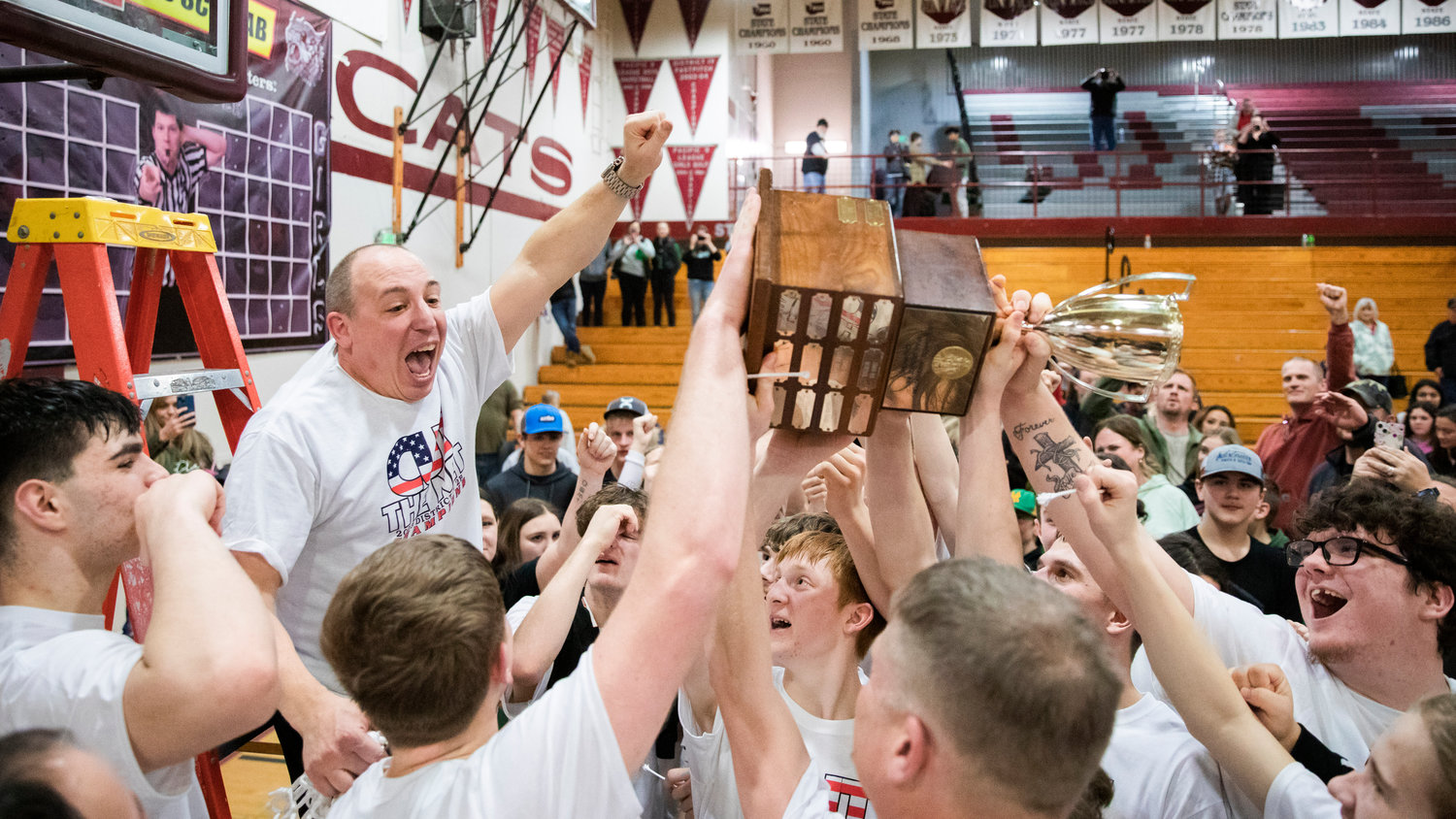 Morton-White Pass Head Coach Chad Cramer cheers with athletes and fans after defeating the Adna Pirates in the 2B District Championship game Saturday night at W.F. West.