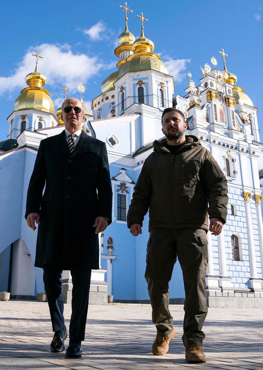 U.S. President Joe Biden, left, walks with Ukrainian President Volodymyr Zelenskyy in front of St. Michael's Golden-Domed Cathedral during an unannounced visit, in Kyiv, on Monday, Feb. 20, 2023. (Evan Vucci/Pool/AFP/Getty Images/TNS)