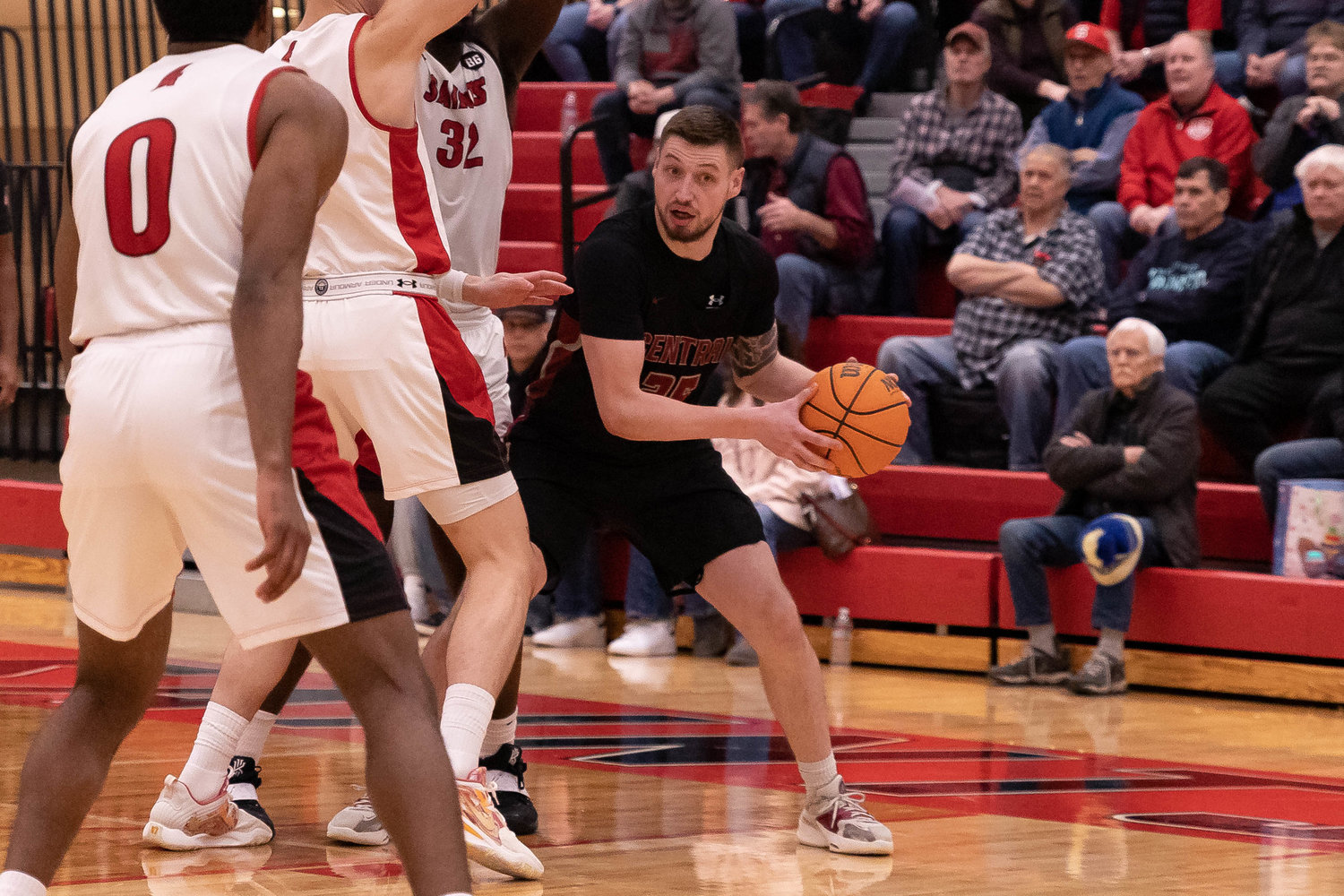 Central Washington forward Matt Poquette looks to pass out of a double team in a 77-75 win over Saint Martin's at Marcus Pavilion Feb. 23.