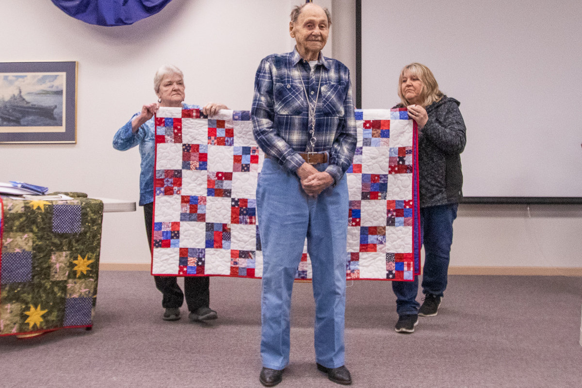 Retired Navy Chief George Whitlock prepares to receive his handmade quilt from Veterans Memorial Museum Quilts of Valor chapter on Thursday afternoon.