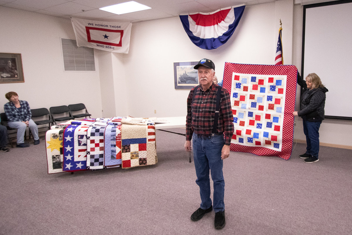 Navy veteran Edmund Armit stands ready to recieve his handmade quilt from the Veterans Memorial Museum Quilts of Valor chapter on Thursday afternoon.