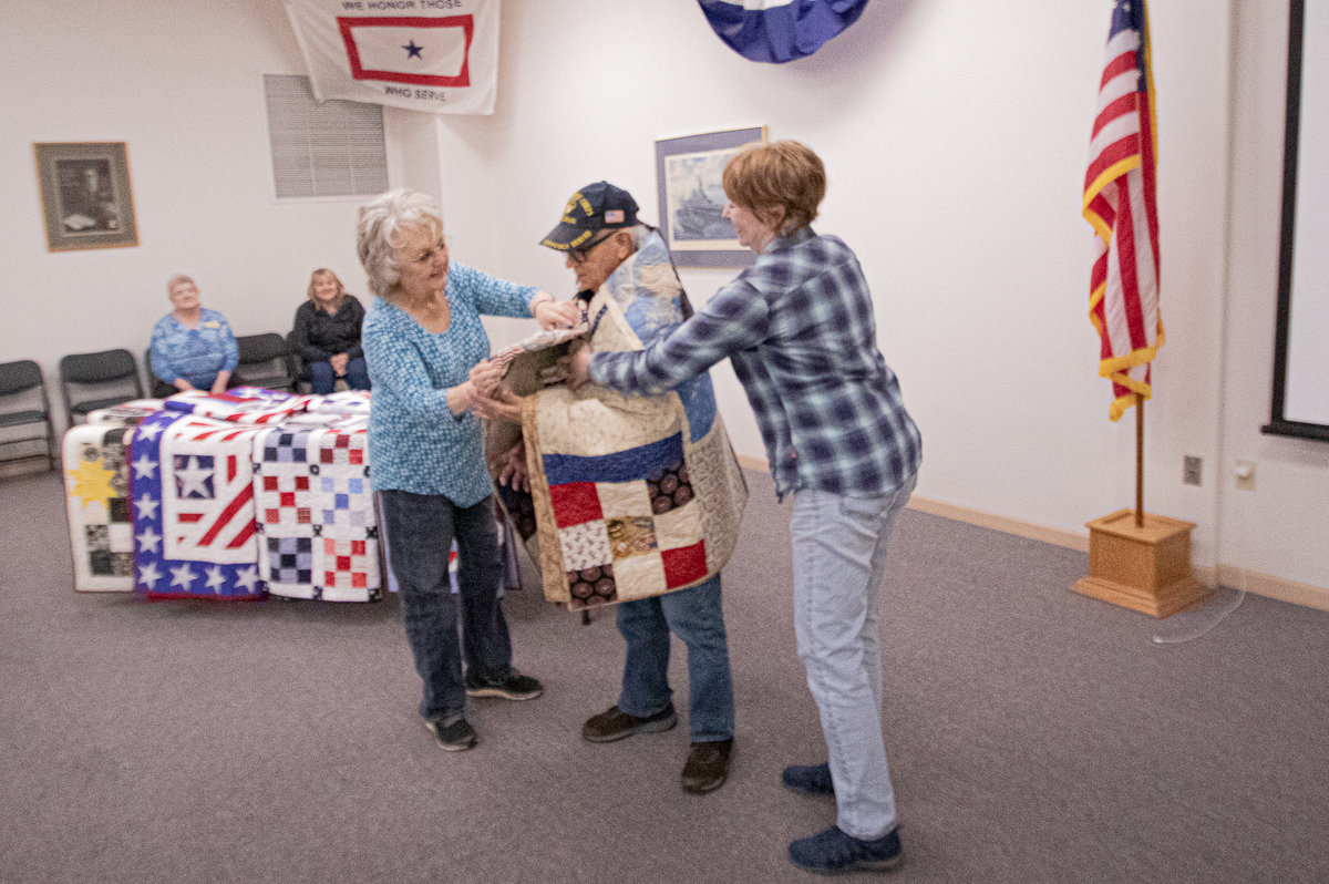 Marine Corps veteran D'orr Krambule recieves his handmade quilt from the Veterans Memorial Museum Quilts of Valor chapter on Thursday afternoon.