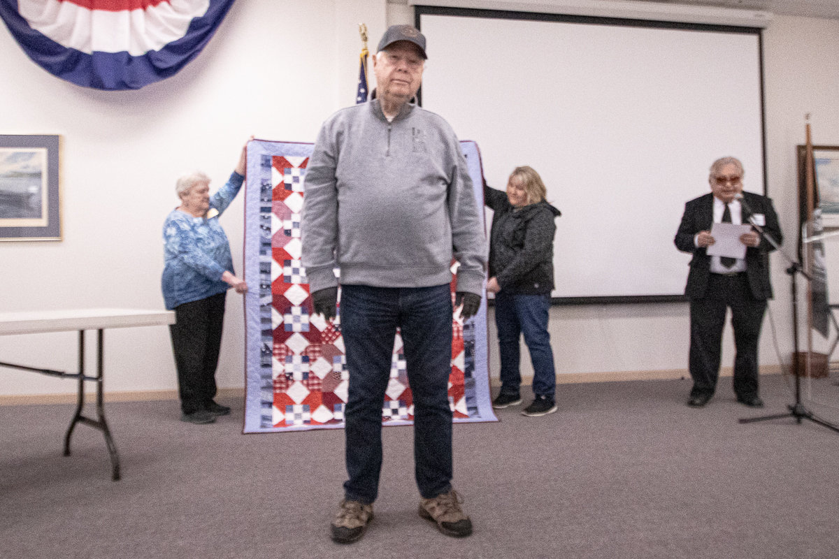 Navy veteran Ron Jennings prepares to recieve his handmade quilt from the Veterans Memorial Museum Quilts of Valor chapter Thursday afternoon.