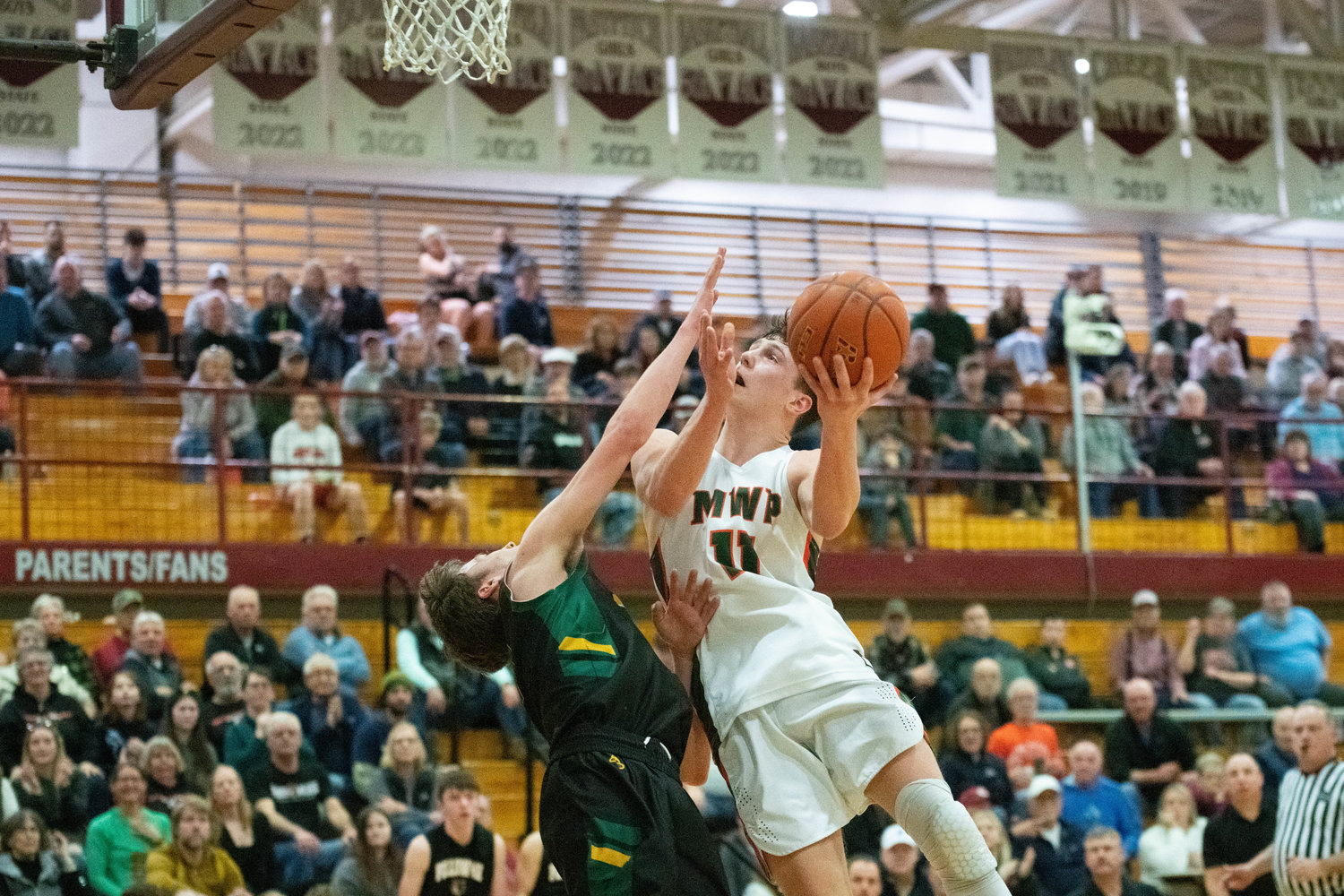 Hunter Hazen goes up to the basket through contact during MWP's win over Northwest Christian in the 2B state tournament's opening round, at Chehalis on Feb. 25.