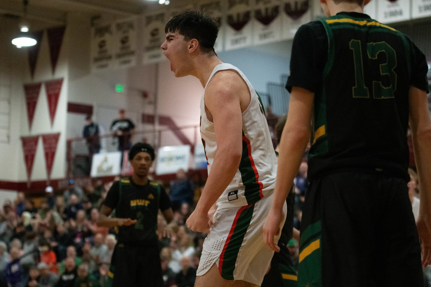 Josh Salguero lets out a yell after making a bucket through contact during MWP's opening-round win over Northwest Christian in the 2B State basketball tournament on Feb. 25 in Chehalis.