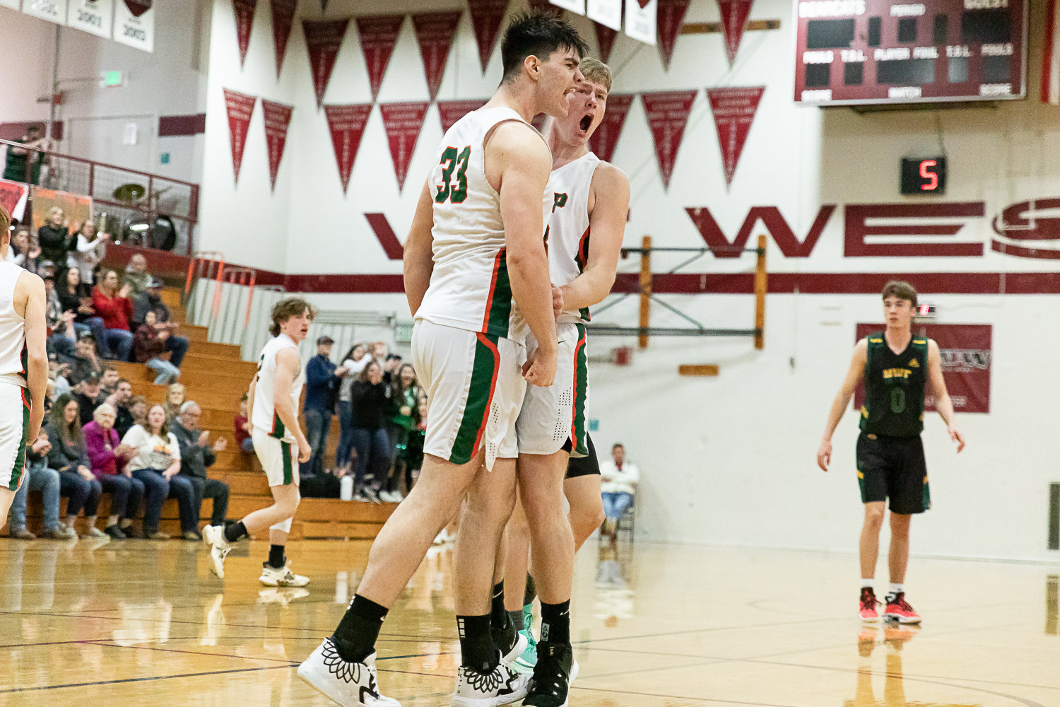 Morton-White Pass center Josh Salguero celebrates with teammate Jace Peters after an and-one in an opening round of state matchup against Northwest Christian (Colbert) at W.F. West Feb. 25.
