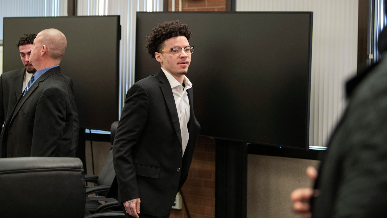 Lathan Echols, known professionally as “Lil Mosey,” stands up to look back at the gallery after a jury reached a not-guilty verdict in Chehalis on Thursday.