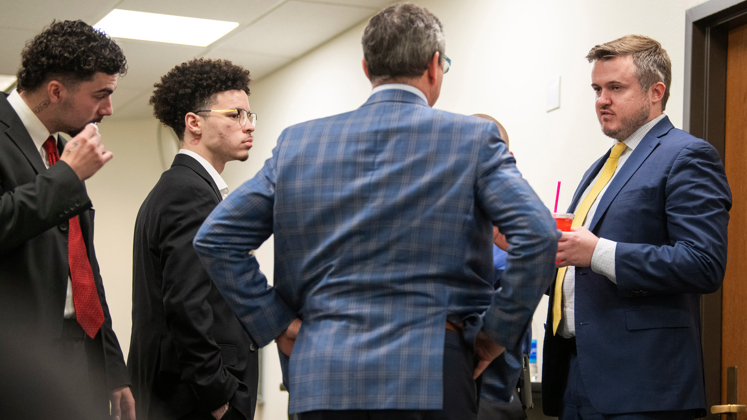 Lathan Echols and Joshua Darrow talk with legal counsel inside the Lewis County Law and Justice Center in Chehalis before a jury reached a not-guilty verdict on Thursday.