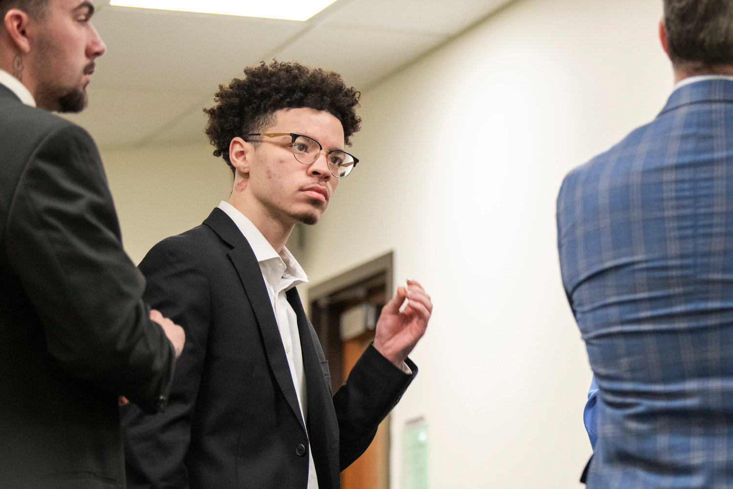 Lathan Echols and Joshua Darrow talk with legal counsel inside the Lewis County Law and Justice Center in Chehalis before a jury reached a not-guilty verdict on Thursday.