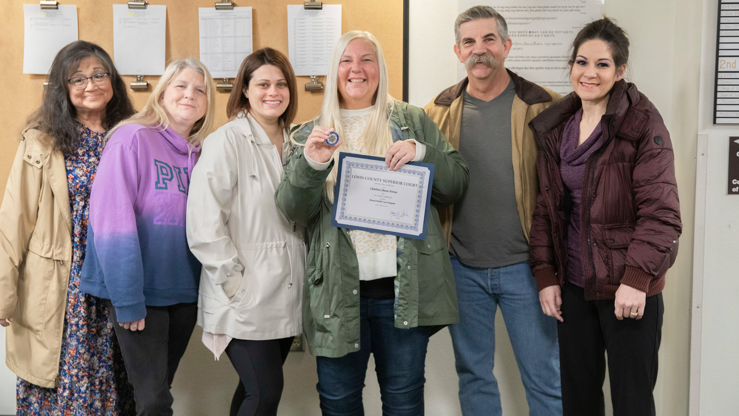 Charlotte Sharon Norton smiles for a photo with supporters after successfully completing the Mental Health Court Program on Thursday in Lewis County Superior Court.
