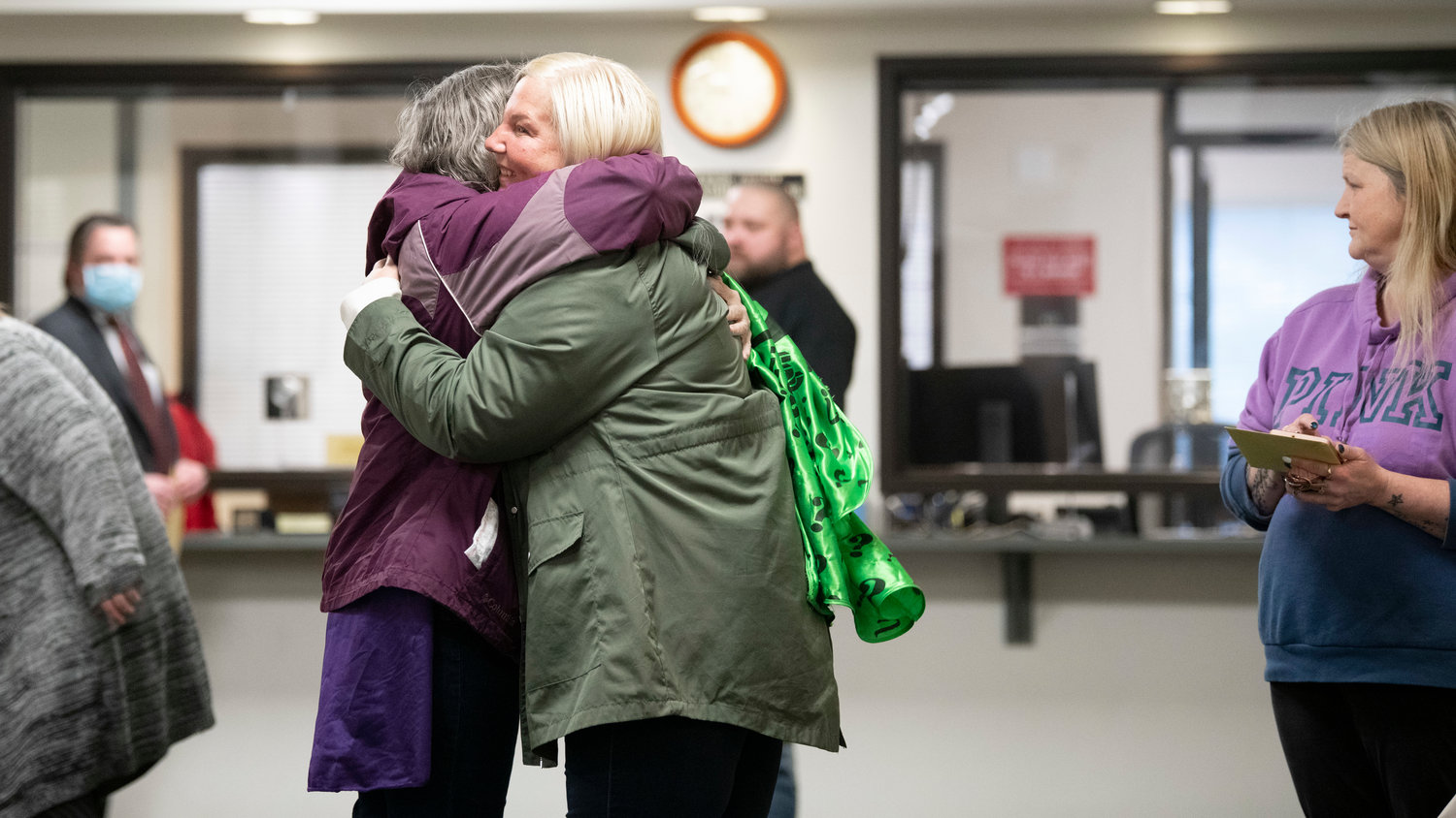 Charlotte Sharon Norton hugs supporters before receiving a medallion for successfully completing the Mental Health Court Program on Thursday in Lewis County Superior Court.