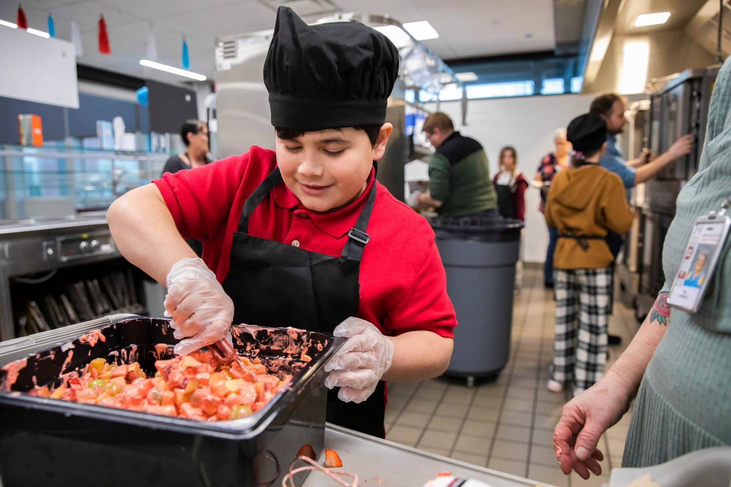 CJ Delarosa, 11, prepares a fruit salad during the Future Chefs National Challenge at Orin Smith Elementary in Chehalis on Thursday.
