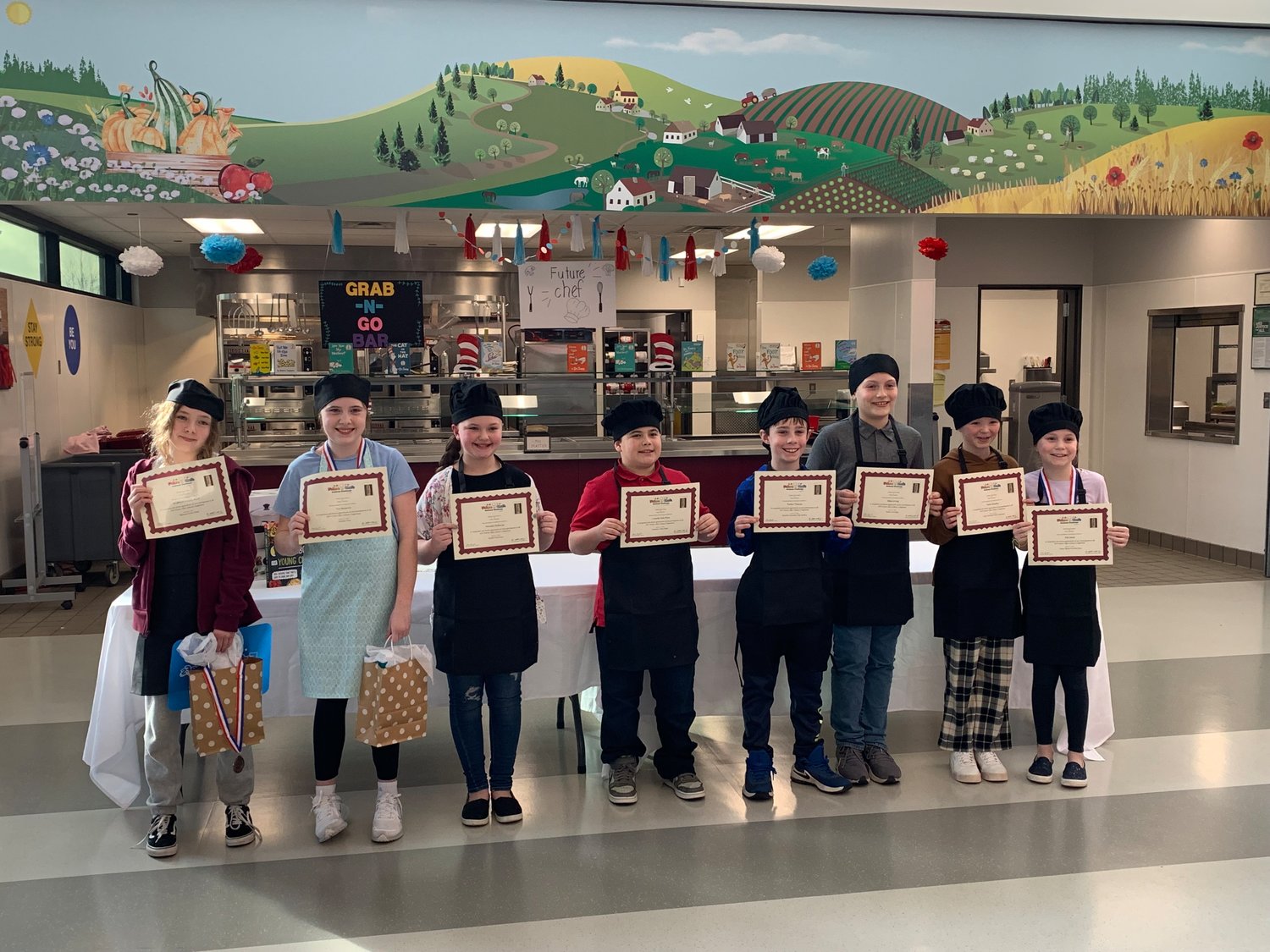 Eight Orin Smith Elementary School students who competed in the Future Chefs National Challenge on Thursday hold their certificates.