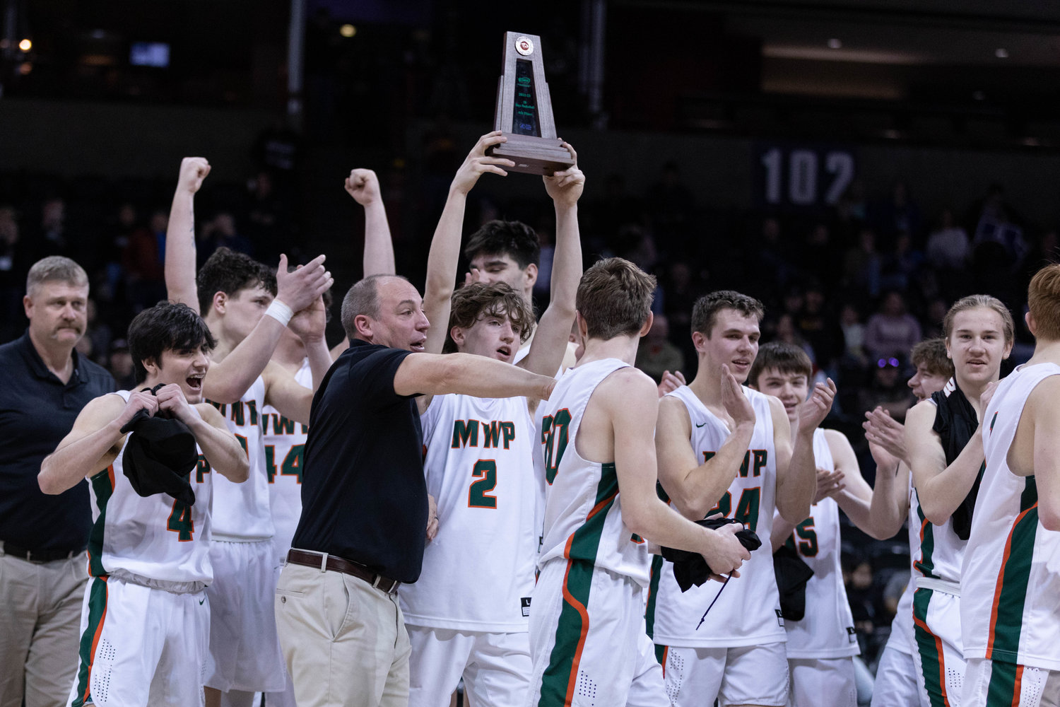 The Morton-White Pass boys basketball team celebrates with the 2B fourth-place trophy at Spokane Arena March 3.