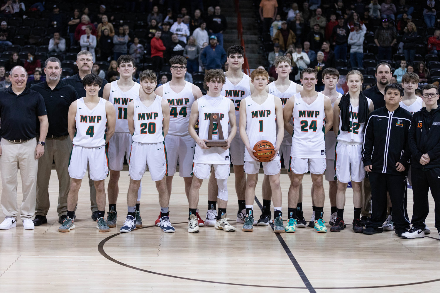 The Morton-White Pass boys basketball team poses with the 2B state fourth-place trophy at Spokane Arena March 3.