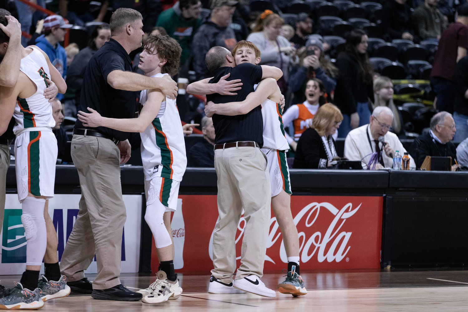 Morton-White Pass guard Jake Cournyer hugs coach Chad Cramer after beating Lake Roosevelt for the 2B state fourth-place trophy at Spokane Arena March 3.