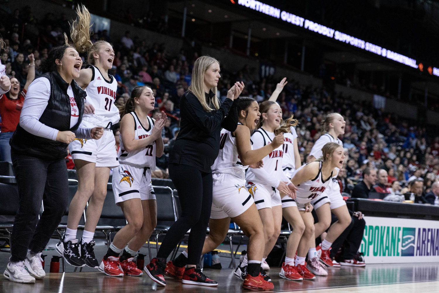 The Mossyrock girls basketball bench celebrates a 3-pointer against Neah Bay in the 1B state championship at Spokane Arena March 4.