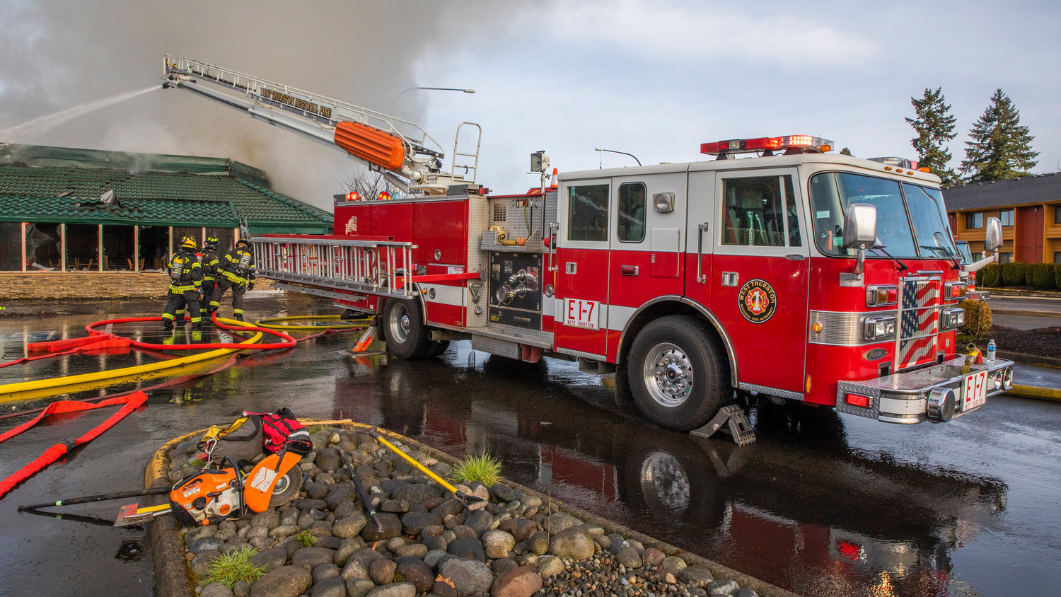 A West Thurston Fire engine sprays water down inside the former location of Papa Pete’s and Shari’s Cafe in Centralia while responding to a commercial structure fire on Sunday.
