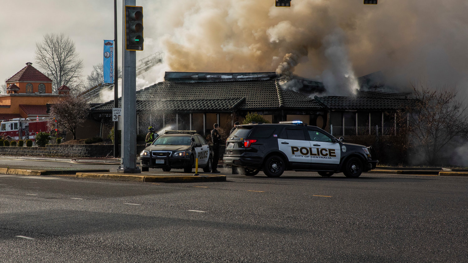 Fire crews and Centralia police respond to the former location of Papa Pete’s and Shari’s Cafe in Centralia on Sunday as smoke billows from the building.