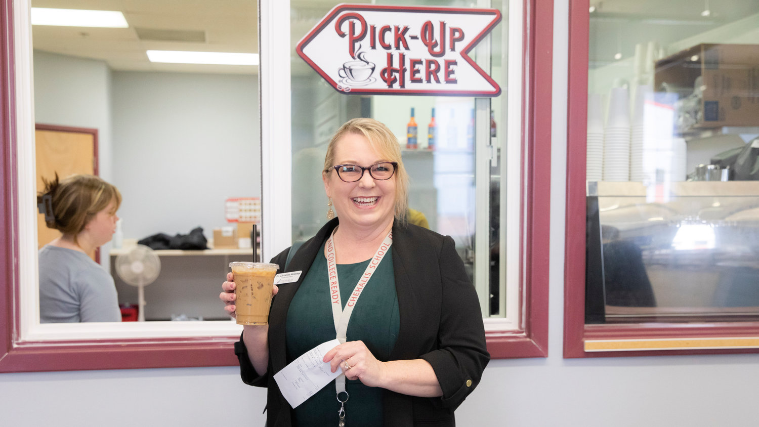 Superintendent Dr. Christine Moloney was served the first drink at "The Crimson & Gray," powered by Lewis County Coffee Co. after the ribbon cutting ceremony in Chehalis.