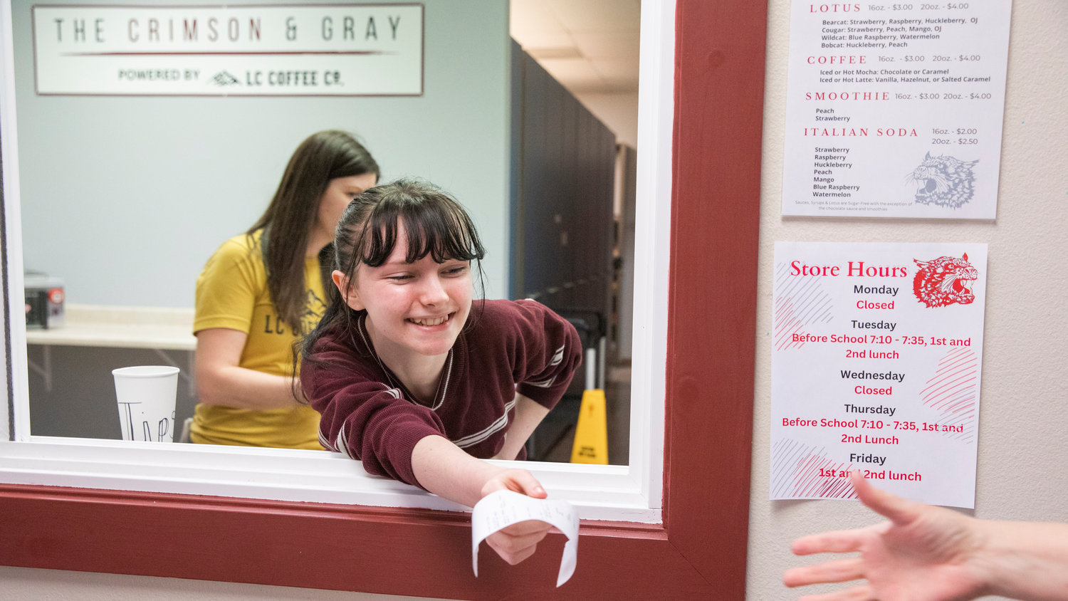Receipts are handed out with smiles at W.F. West High School during a ribbon cutting ceremony on Wednesday for a new student store "The Crimson & Gray," powered by Lewis County Coffee Co. in Chehalis.