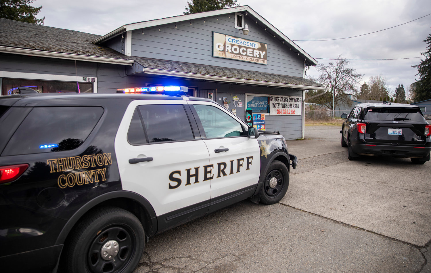 Thurston County Sheriff's Office vehicles sit parked outside of the Crescent Grocery store located at 21816 Old Highway 99 Southwest in Centralia on Wednesday.