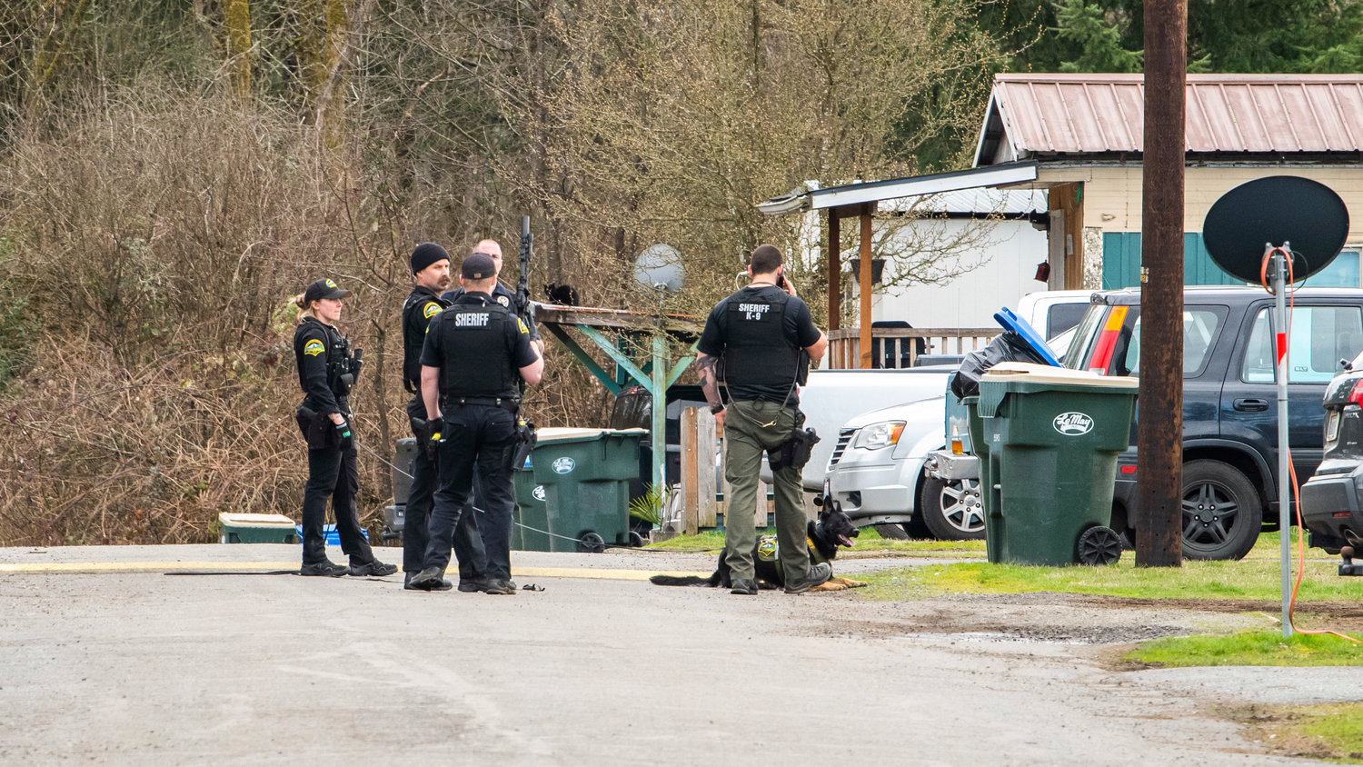 Thurston County Sheriff's Office deputies respond to an area near 201st Avenue Southwest with K9 Isa on Wednesday in Grand Mound.