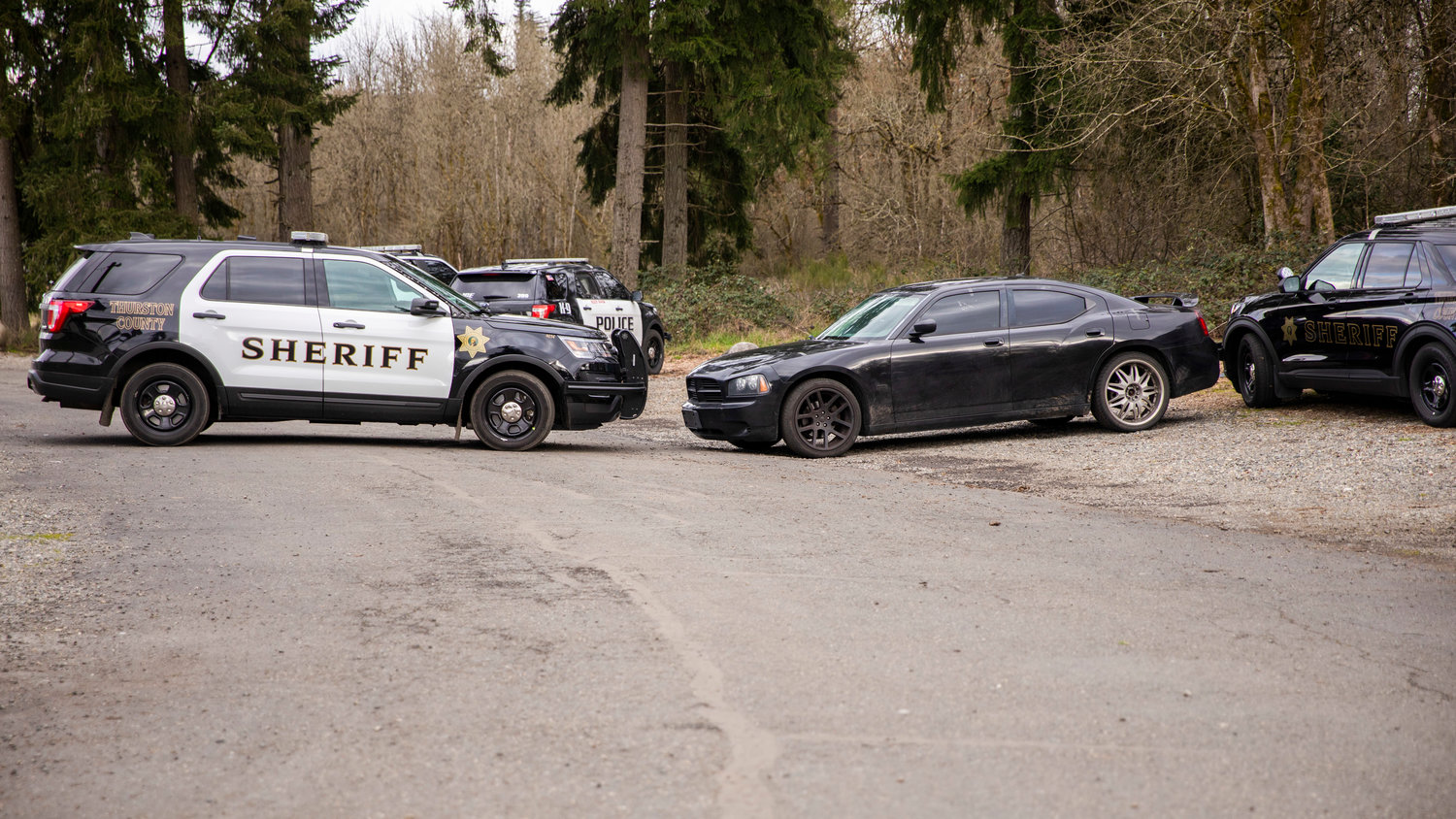 Thurston County Sheriff's Office vehicles block an abandoned Dodge Charger on Wednesday.