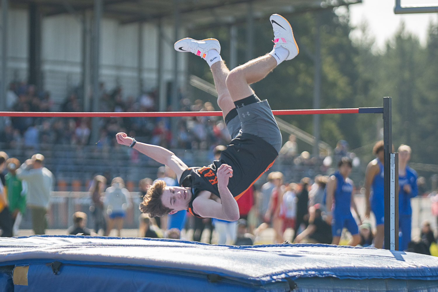 Rainier's Josh Meldrum comes down after clearing the bar in the boys high jump at the Rainier Icebreaker on March 18.