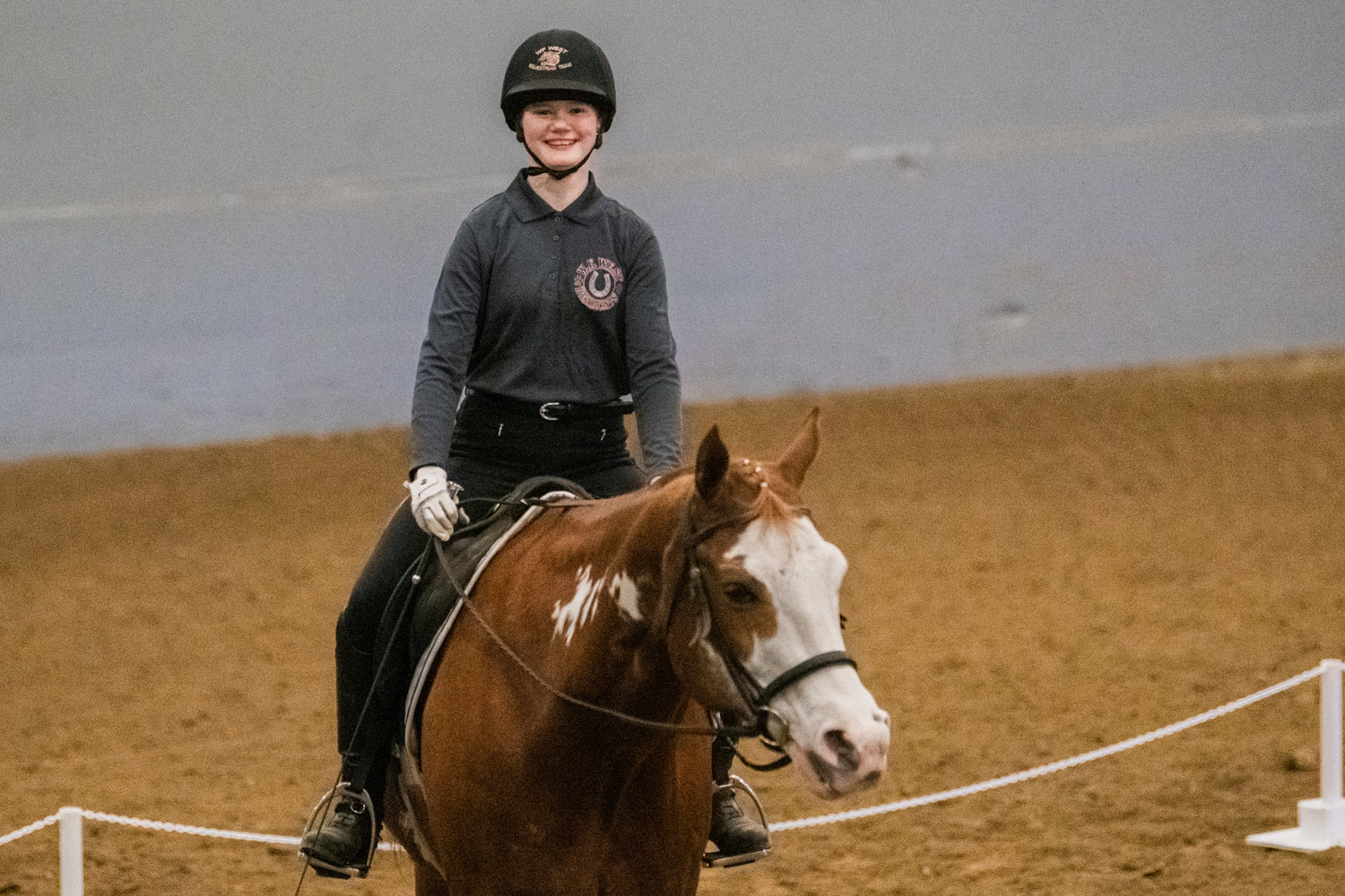 Maizy Samuelson, a freshman who is home-schooled, smiles after completing the dressage event in an equestrian meet on Saturday at the Grays Harbor County Fairgrounds.