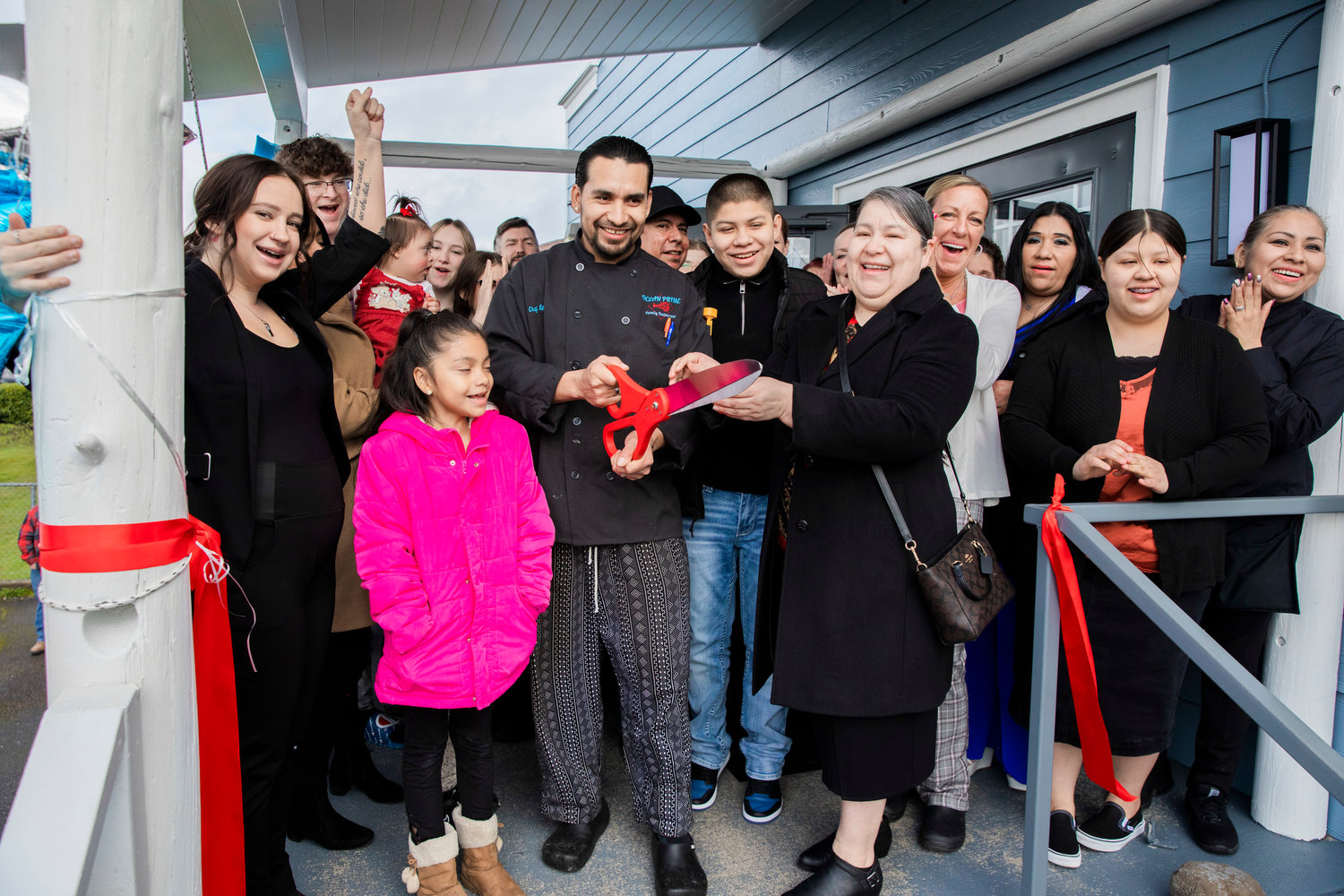 Hailie Haubrick raises her hand and cheers as Chef Eyner "Rene" Cardona cuts a ribbon during a grand opening ceremony alongside his wife Odilia Gaspar and General Manager Kristi Beebe Monday morning in Chehalis. Located at the former Kit Carson Family Restaurant building at 107 SW Interstate Ave., Ocean Prime’s menu will feature a variety of items, such as ribeye, tomahawk steaks, king salmon, ribs, soups, sandwiches, pasta and salads. For more information and to view Ocean Prime Family Restaurant’s full menu, visit its Facebook page.